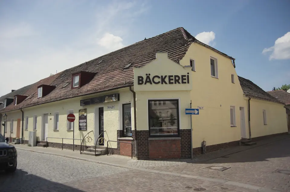 Niedriges Altstadthaus mit Bäckerei an der gepflasterten Bäckerstraße